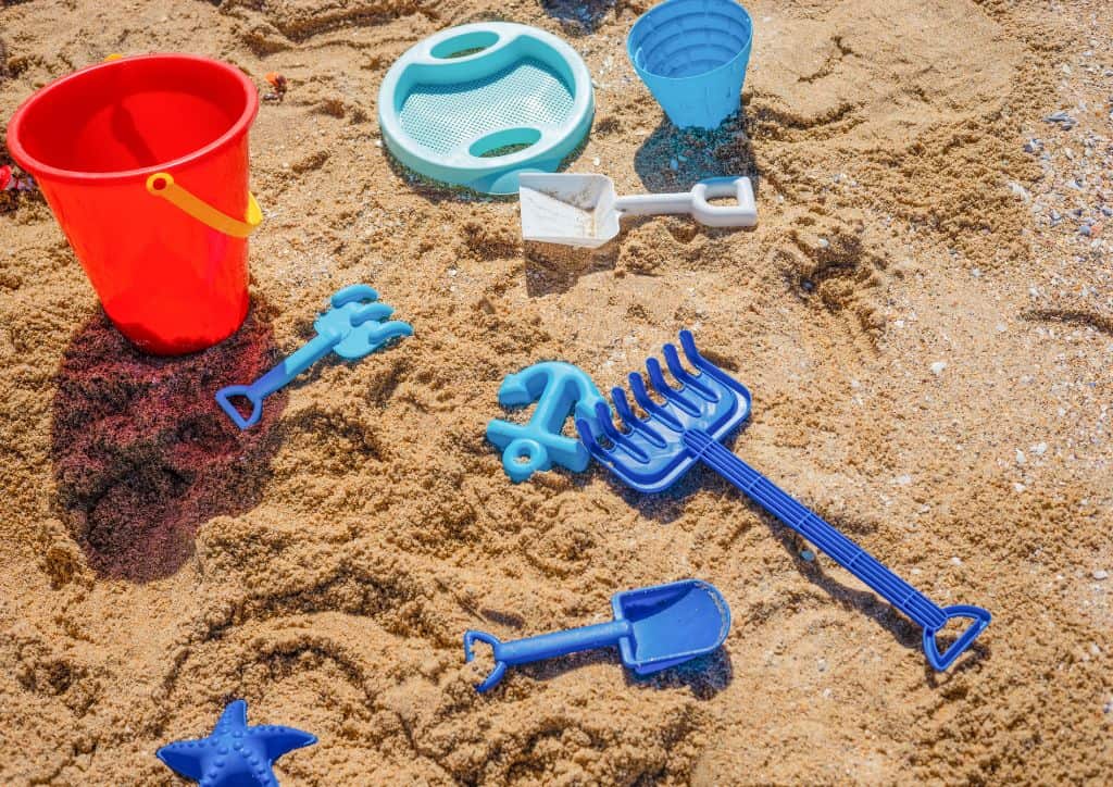 Beach toys on the sand like the ones that kids can play with at a resort in Park Rapids, MN.