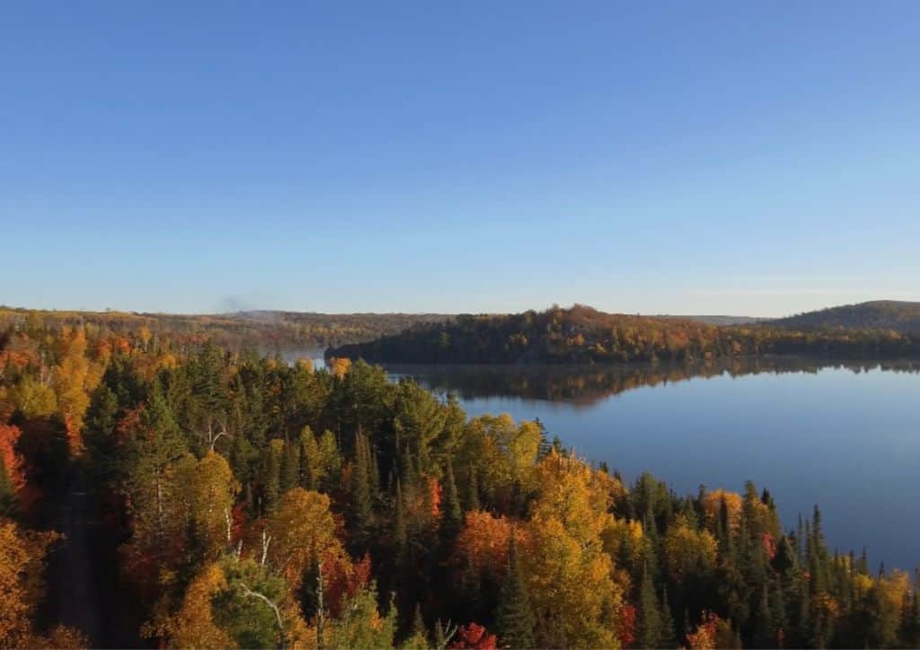 A view over a lake with colorful fall foliage.