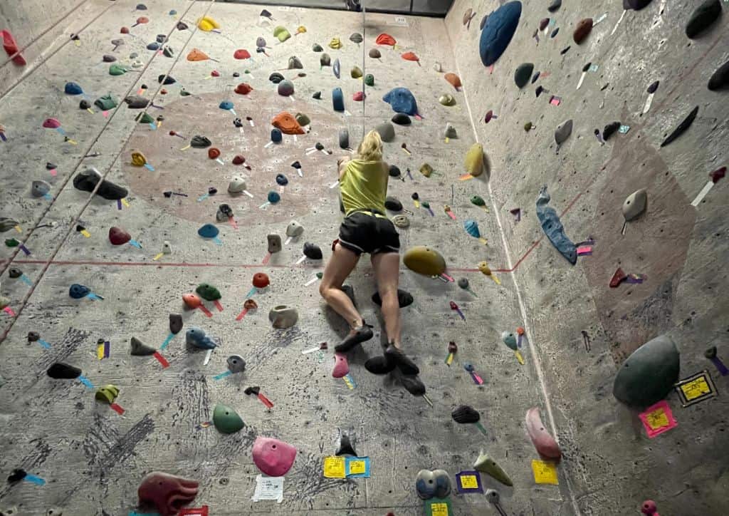Myself doing rock climbing at an indoor gym.