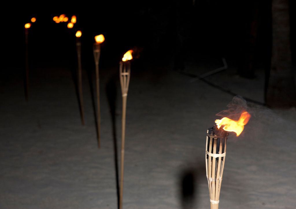 Tiki torches lined up in a row.