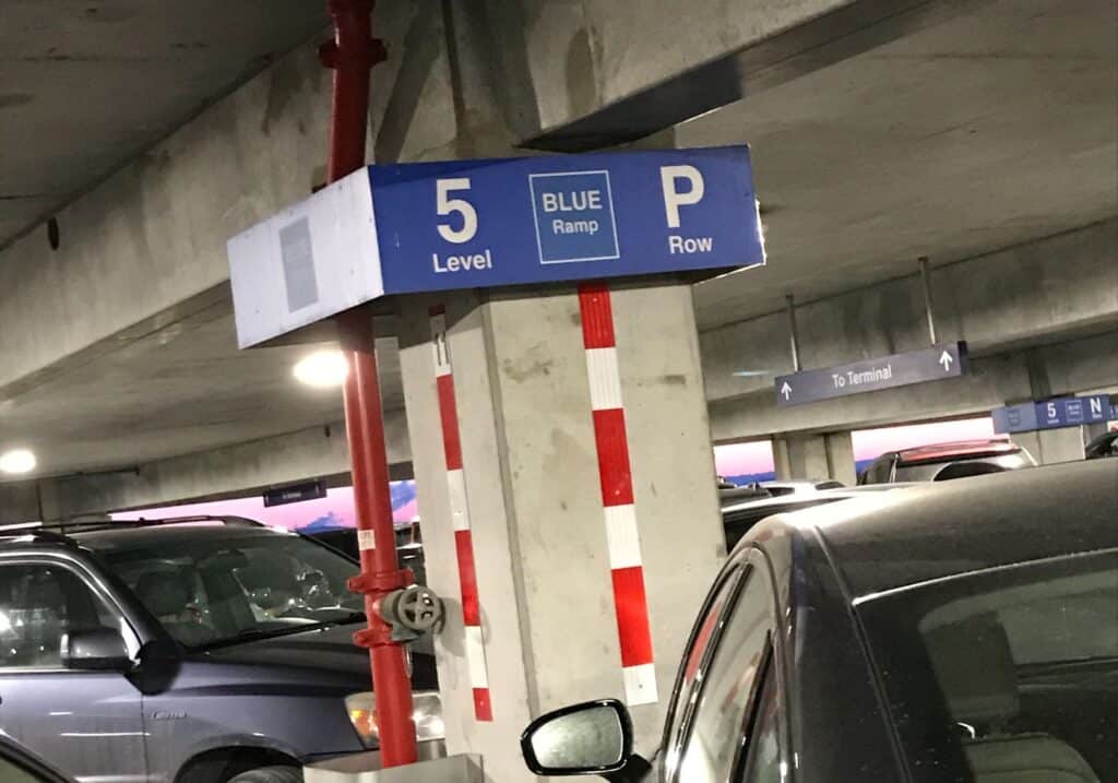 A parking sign at the parking lot at the airport.