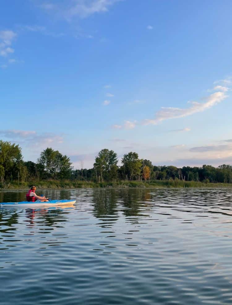 A person kayaking on a lake.