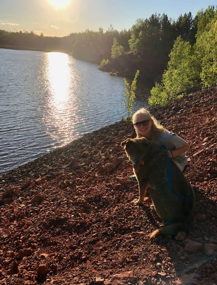 Myself and my dog at a dog friendly beach in Minneapolis on the shore.