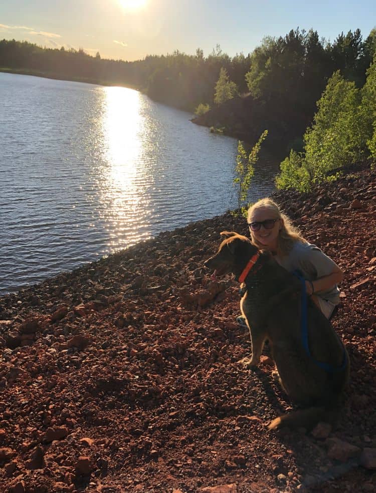 Myself and my dog on the shores of a lake together.