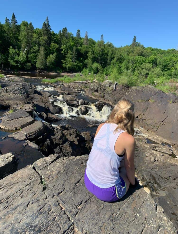 Myself sitting on a rock near the river in Jay Cooke.