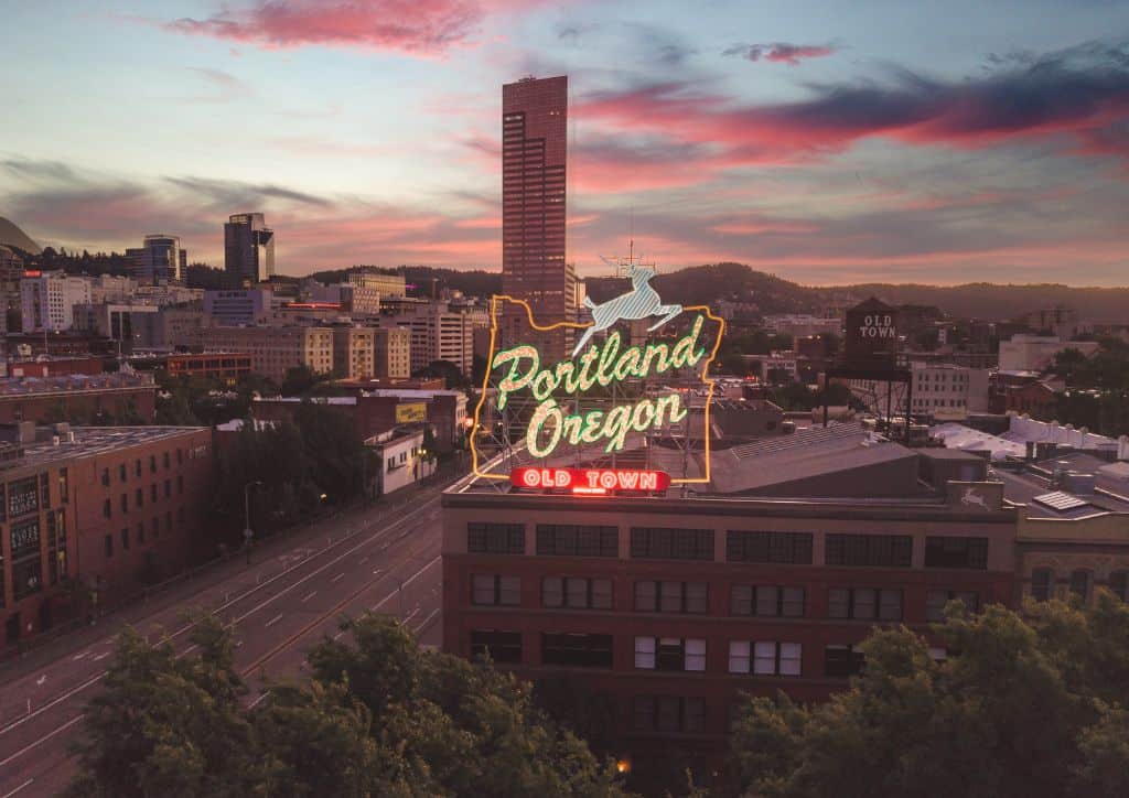 A sign that reads 'Portland Oregon' within the city.