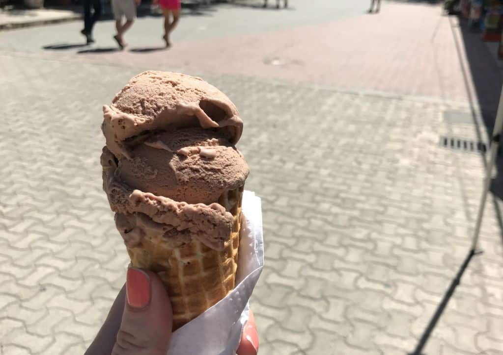 A waffle cone with ice cream in it being held in Duluth, MN.