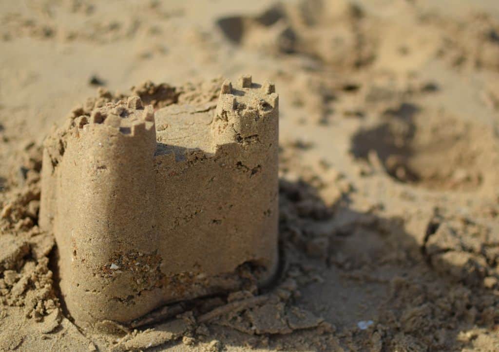 A sandcastle that has been built on a beach.