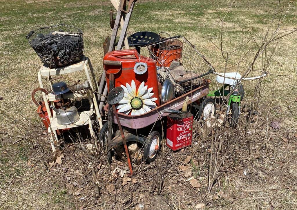 A pile of metal yard decor in a lawn.