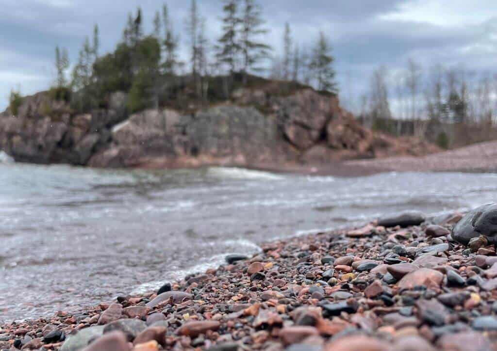 Rocks on the shoreline of a beach on Lake Superior.