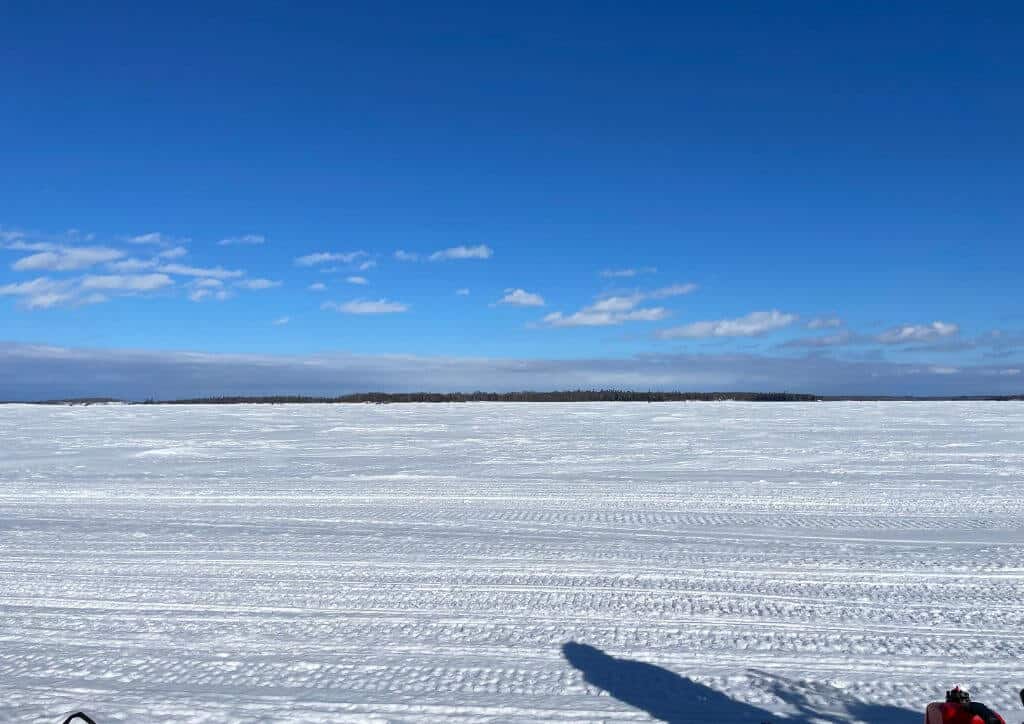 A snow covered field that looks like winter in Minnesota or North Dakota.