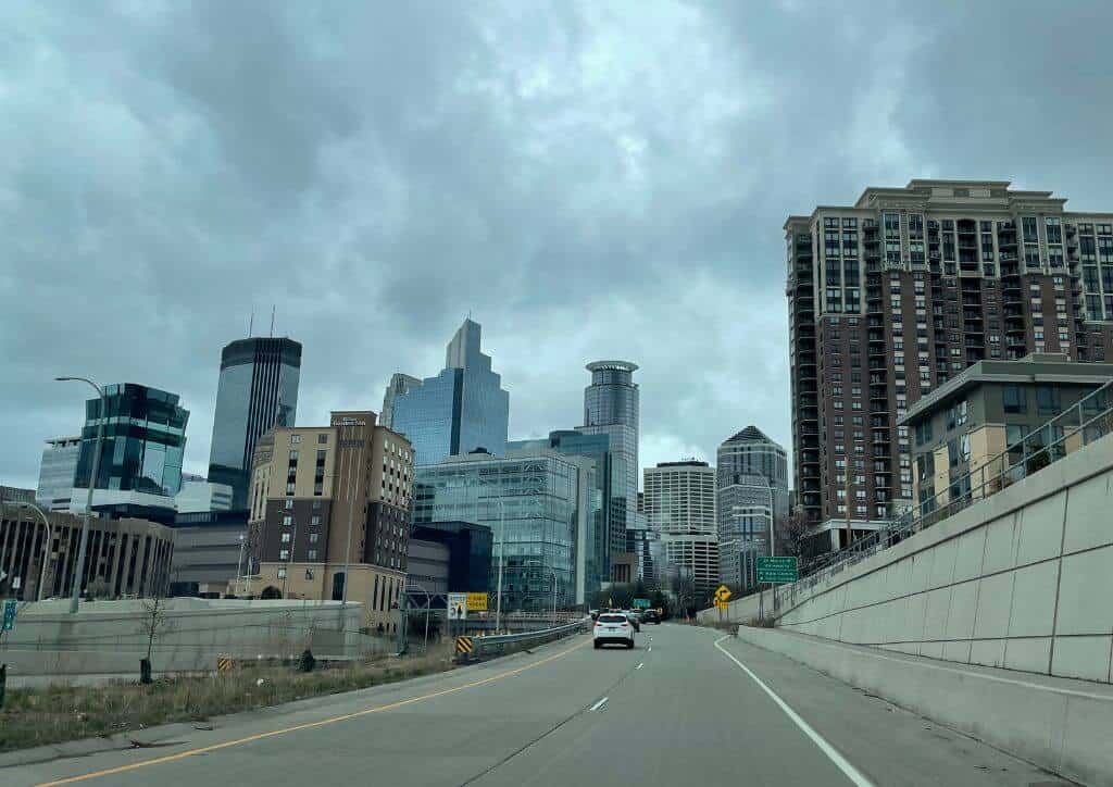 Minneapolis as seen from the road with many skyscrapers ahead.